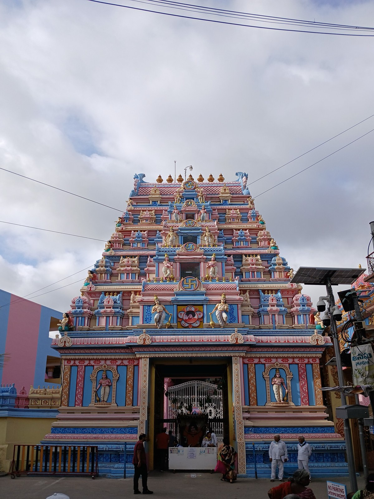 The rose, blue and gold gopuram tower at the entrance to Sai Kulwant Hall
