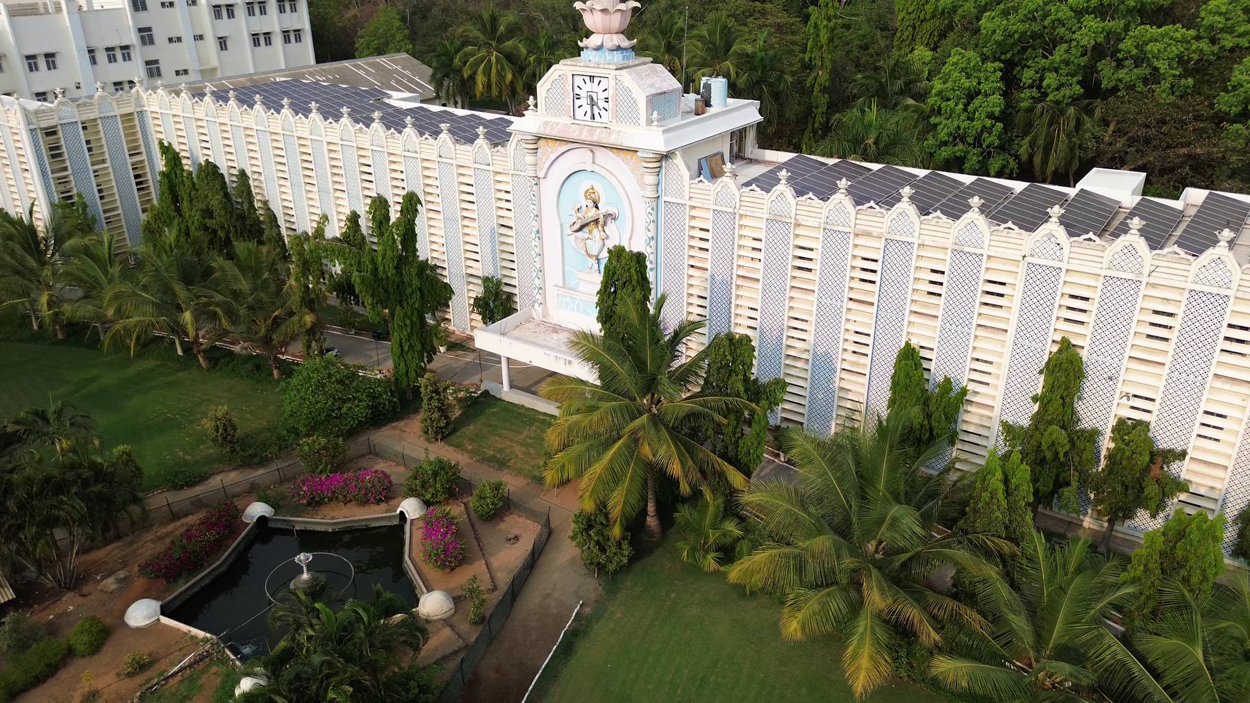 The Institute's main building amid palms and flowering gardens, from above